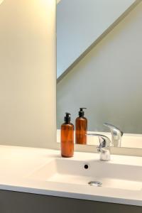a bathroom sink with two soap bottles on it at Central City Flats on Best Location by Round Tower in Copenhagen