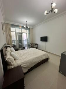 a bedroom with a bed and a television in it at Cozy Private Studio APT in Al Mamzar Sharjah in Sharjah