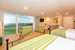 a hotel room with two beds and a large window at Sligo Sea Barn in Sligo