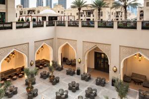 an indoor courtyard of a building with palm trees at The Heritage Hotel, Autograph Collection in Dubai