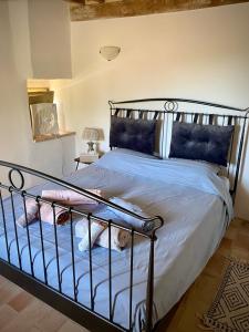 a bedroom with a bed with a wrought iron headboard at Casa Al Fondo in Gualdo di Macerata