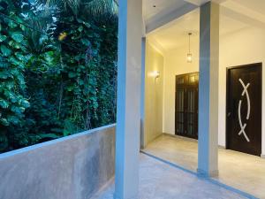 an indoor plant wall in a hallway with a door at LaRoy Mirissa-Introducing Smart Hotel in Mirissa