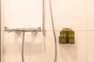 a bathroom with two green bottles of soap in a shower at Sligo Sea Barn in Sligo