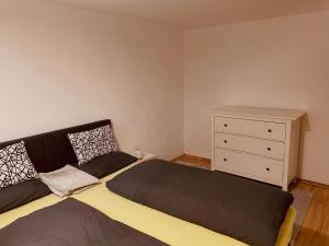 a bedroom with a bed and a dresser at Appartment Schmidtner in Ansbach