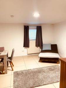 a room with a bed and a table and a window at Appartment Schmidtner in Ansbach