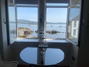 a room with a window with a view of the ocean at Millport Beach Apartment, Crichton St, sea views in Millport