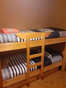 two sets of bunk beds in a room at Studio cabine au cœur de la montagne Les Memises in Thollon