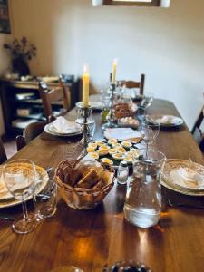 a wooden table with plates and bowls of food on it at Tuscany Escape in Borgo a Mozzano +18 photos