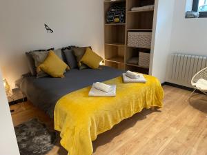 a bedroom with a bed with two towels on it at Appartement - La Meute in Magland