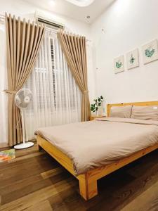a bedroom with a large bed and a window at LaLa Villa Hue in Hue +13 photos