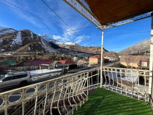 a balcony with a view of the mountains at Urban Apartment Kazbegi in Stepantsminda