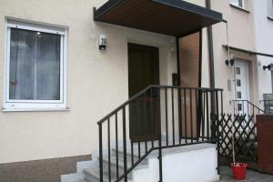 a house with a staircase leading to a door at Beishan Appartements Nürnberg in Nürnberg +4 photos