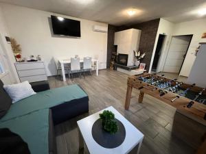 a living room with a couch and a table at Holiday Home Sunset in Grabrovnik +5 photos