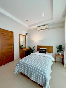 1 dormitorio con 1 cama con manta azul y blanca en S303 Good Apartment Chalong Na-kok, en Phuket