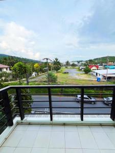 a balcony with a view of a street at S303 Good Apartment Chalong Na-kok in Phuket Town +9 photos