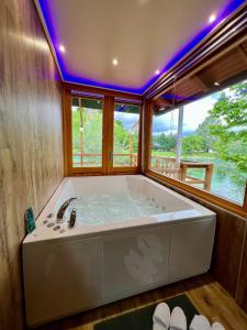 a large bath tub in a room with a window at Haus Palazzo in Bosanska Krupa