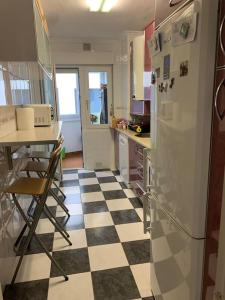 a kitchen with a black and white checkered floor at Apartamento en Liencres in Liencres