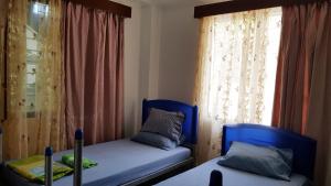 a bedroom with two beds and a window at Jetpoint- Central Nadi 2 bedrm in Nadi