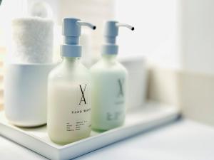 three bottles of hand soap on a shelf at Villa Astoria - Suiten am Meer in Kühlungsborn