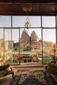 a room with a large window with a view at Sultan Cave Suites in Göreme