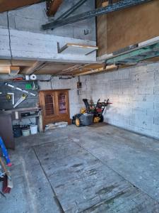 an empty garage with a motorcycle parked in it at LES BOUVREUILS in Les Deux Alpes