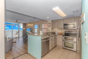 a kitchen with stainless steel appliances and a dining room at Atlantica 757 in Myrtle Beach