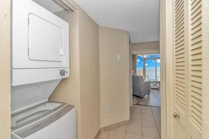 a kitchen with a washer and dryer and a living room at Atlantica 757 in Myrtle Beach +43 photos