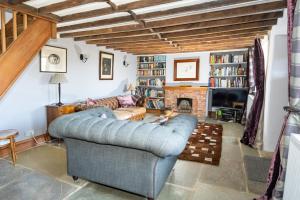 sala de estar con sofá y chimenea en Characterful Cottage in Heart of Dorset en Buckland Newton