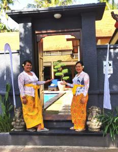 two women standing in front of a house at Villa Silence in Lovina