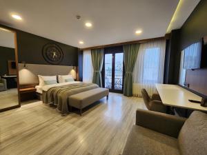 a bedroom with a bed and a desk and a couch at Taksim Landhouse in Istanbul