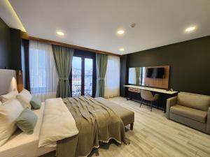 a bedroom with a bed and a desk and a television at Taksim Landhouse Hotel 1 Min to Taksim Square in Istanbul +42 photos