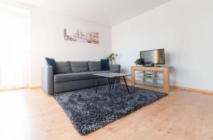 a living room with a couch and a table at Šeškinės 61 Spacious Cozy Apartment in Vilnius