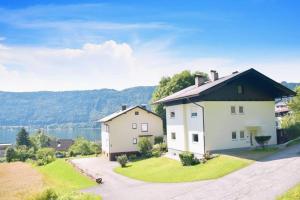 a large white house with a black roof at Ferienhaus Julia - Ossiacher See in Sattendorf