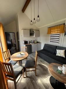 a living room with a couch and a table and chairs at Słoneczny Horyzont in Zastań