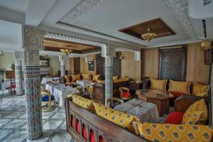 a lobby with chairs and tables and a room filled with at Darif's Riad Fes & Spa in Fez