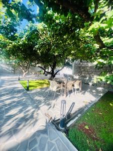 a table and chairs in a park under a tree at MarNar Hotel in Yerevan