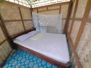 a small bed in a yurt with a window at Ocam Ocam Casadyan Inn in New Busuanga