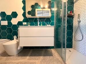 a bathroom with a toilet and a sink and a shower at Charlie Home - Heart of Sardinia in Costa Paradiso +14 photos