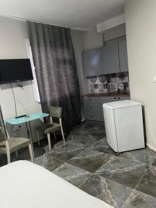 a small kitchen with a table and a refrigerator at Zerya suites in Istanbul