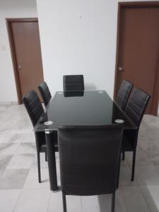 a black table and chairs in a room at EMPRESS SIGNATURE in Kuala Lumpur