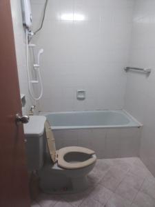 a bathroom with a toilet and a bath tub at EMPRESS SIGNATURE in Kuala Lumpur
