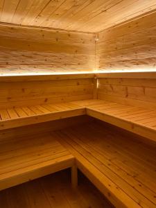 an empty wooden sauna with wooden shelves at Beim Has’n in Rimsting