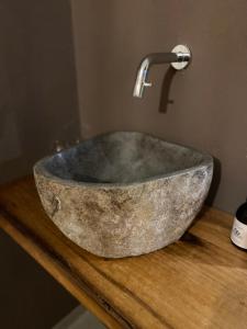 a stone sink with a faucet on top of a counter at Beim Has’n in Rimsting