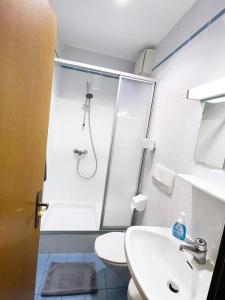 a bathroom with a shower and a sink and a toilet at Frühstückspension Meyer, Familie Orthacker in Graz