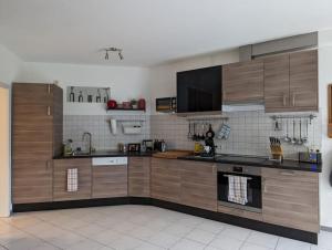 a large kitchen with wooden cabinets and appliances at Welcome in Weilerbach in Weilerbach