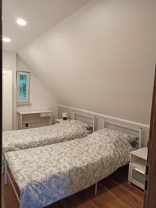 a bedroom with two beds in a room at Mazurska Willa in Kretowiny