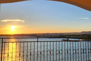 a view of the sunset from a balcony at Úchvatný výhled na moře in Aheloy