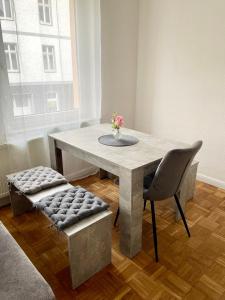 a dining room table and chairs with a vase of flowers at Havel Homes Apartment mit 3 SZ und Netflix in Brandenburg an der Havel