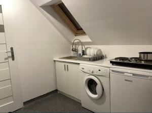 a kitchen with a washing machine and a sink at Seaside Holiday House in Gdańsk