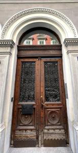 a large wooden door in a building at Appartamento Elegante Teatro Rossetti in Trieste